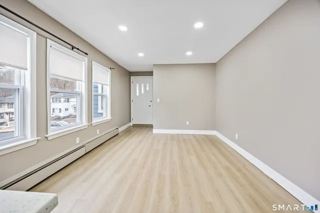 a view of an empty room and a window