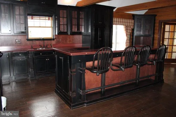 a kitchen with granite countertop a stove a sink and a window