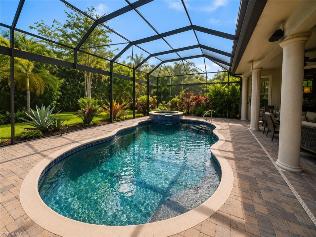 6574 Amarone Lane Naples, FL 34113 - Photo 32 of 44 a view of a swimming pools under an umbrella
