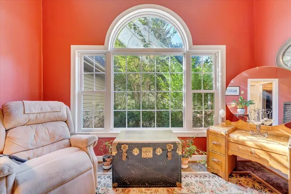 a kitchen with stainless steel appliances granite countertop a stove top oven a sink dishwasher a dining table and chairs with wooden floor