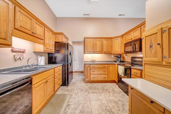 a bedroom with a bed a dresser and mirror