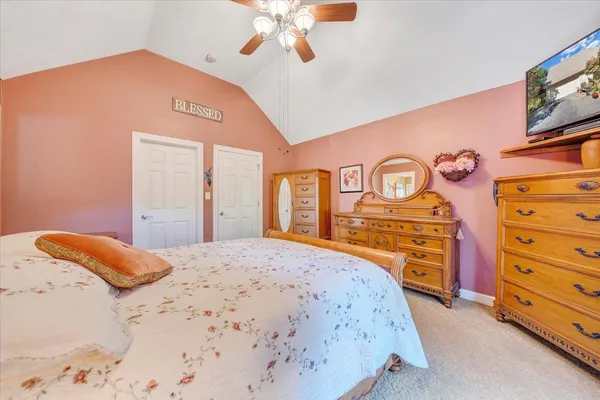 a bedroom with a bed couch and window