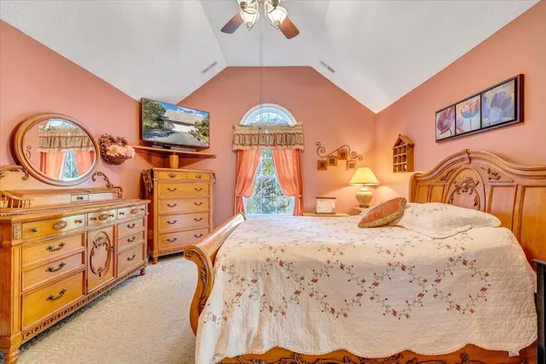 a bathroom with a granite countertop sink a toilet and a mirror