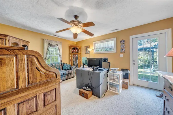 a view of a livingroom with furniture and a chandelier