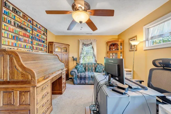 a view of a livingroom with furniture and a window