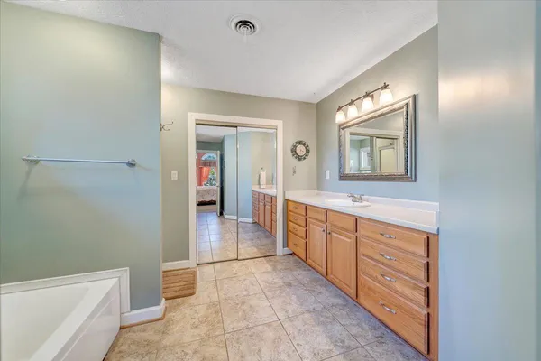 a bedroom with a bed gym equipment and a large window