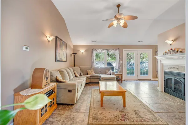 a living room with furniture a fireplace and a flat screen tv