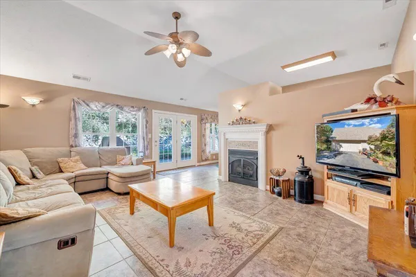 a living room with furniture and a fireplace