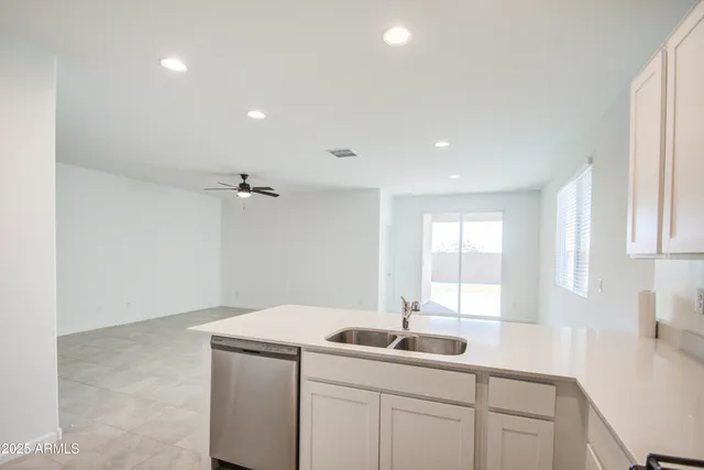 a kitchen with a sink dishwasher and cabinets
