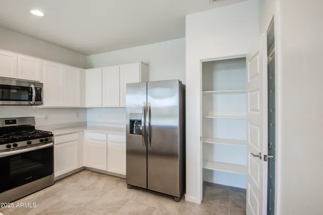 a kitchen with cabinets and stainless steel appliances