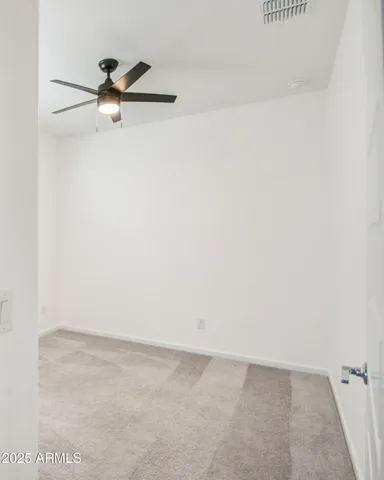 a view of a room with a ceiling fan