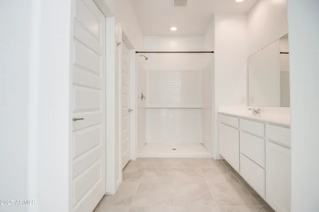 a bathroom with a shower and a sink