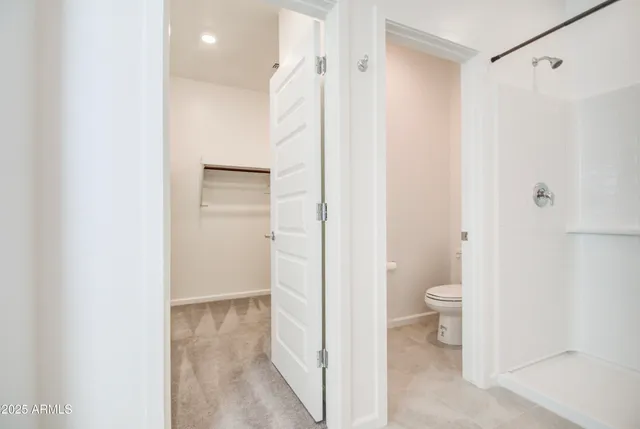 a bathroom with a granite countertop sink mirror and toilet