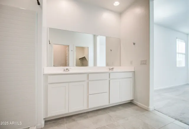a bathroom with a sink vanity and mirror