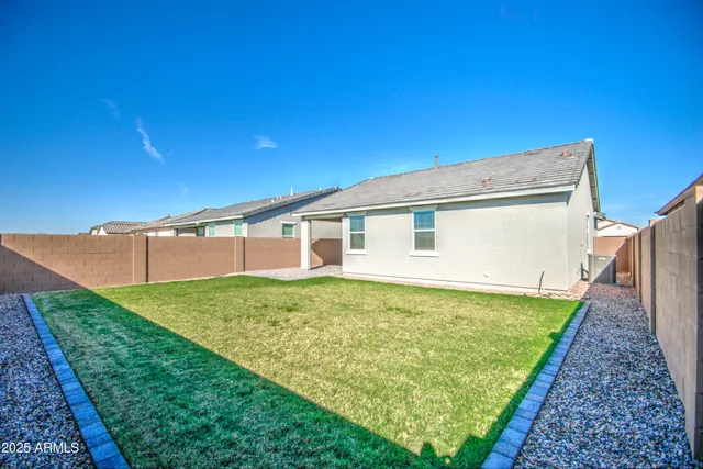 a view of a backyard with plants and an outdoor space