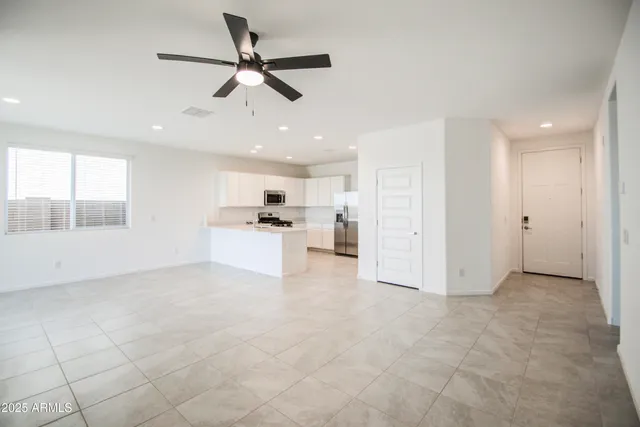 a view of kitchen with white cabinets and window