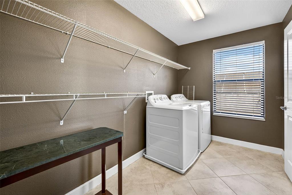 9906 Victory Gallop Loop Ruskin, FL 33573 - Photo 11 of 18 a utility room with cabinets