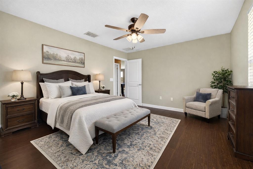 9906 Victory Gallop Loop Ruskin, FL 33573 - Photo 12 of 18 a bedroom with a bed and ceiling fan
