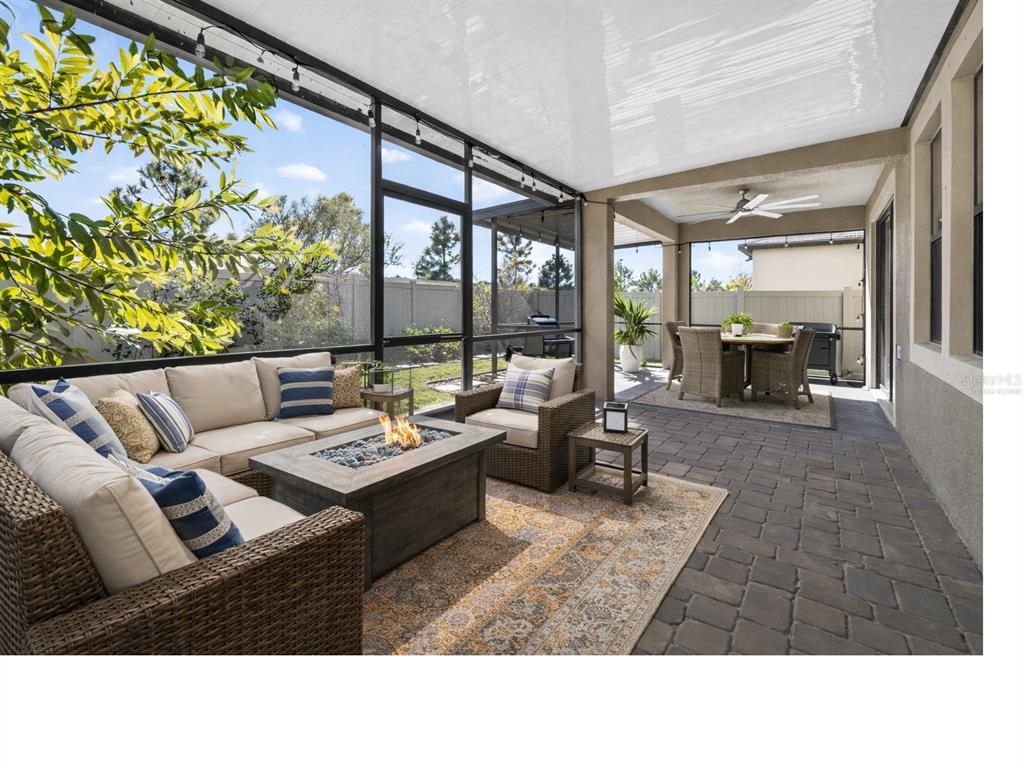 9906 Victory Gallop Loop Ruskin, FL 33573 - Photo 14 of 18 a living room with couches and a table