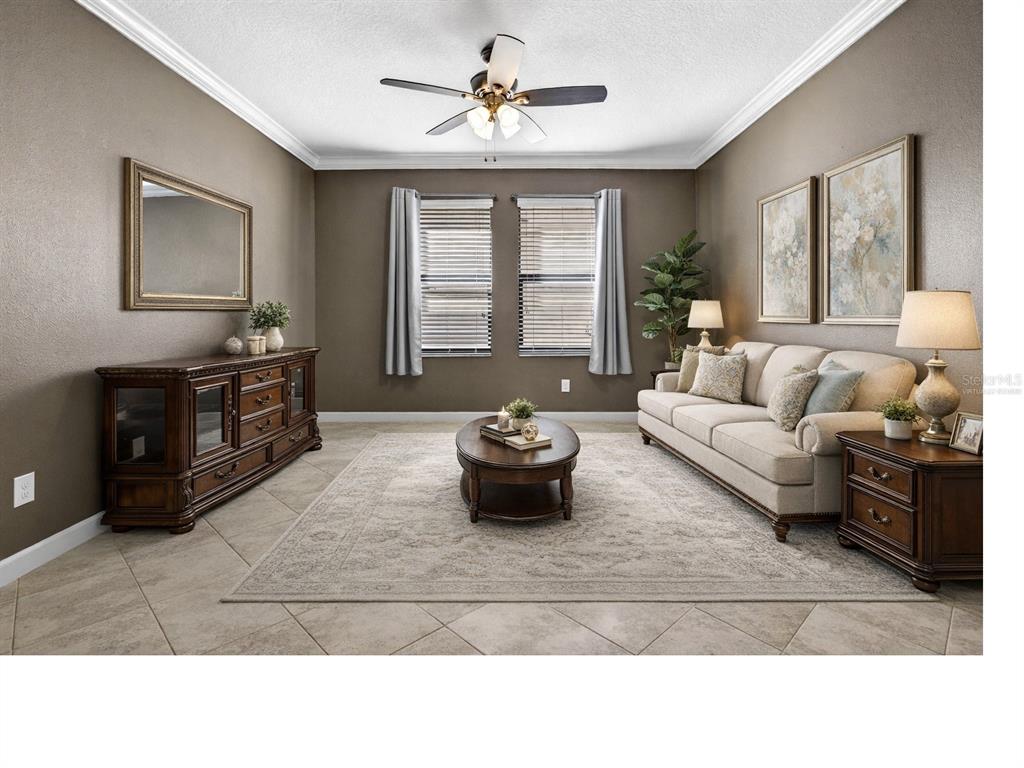 9906 Victory Gallop Loop Ruskin, FL 33573 - Photo 3 of 18 a living room with furniture and a fireplace