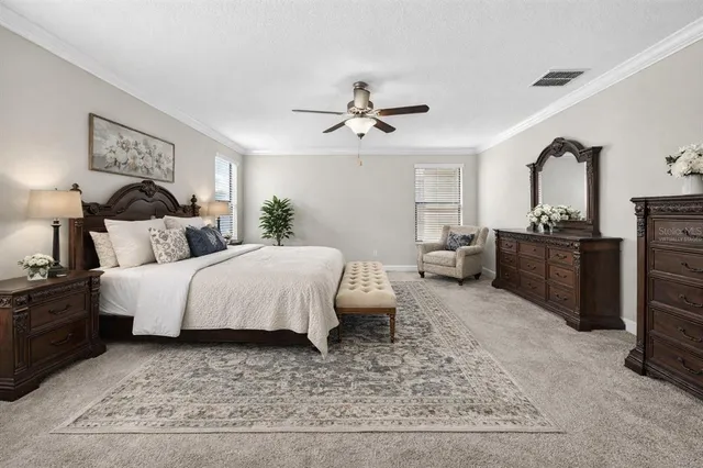 a bedroom with a bed lamps and dresser