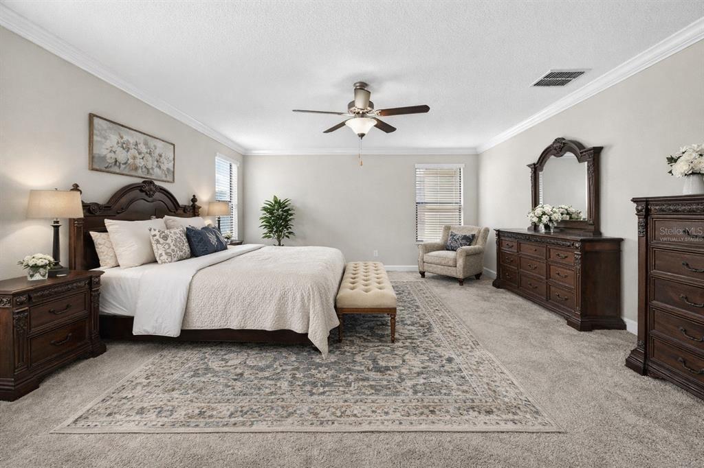 9906 Victory Gallop Loop Ruskin, FL 33573 - Photo 7 of 18 a bedroom with a bed lamps and dresser