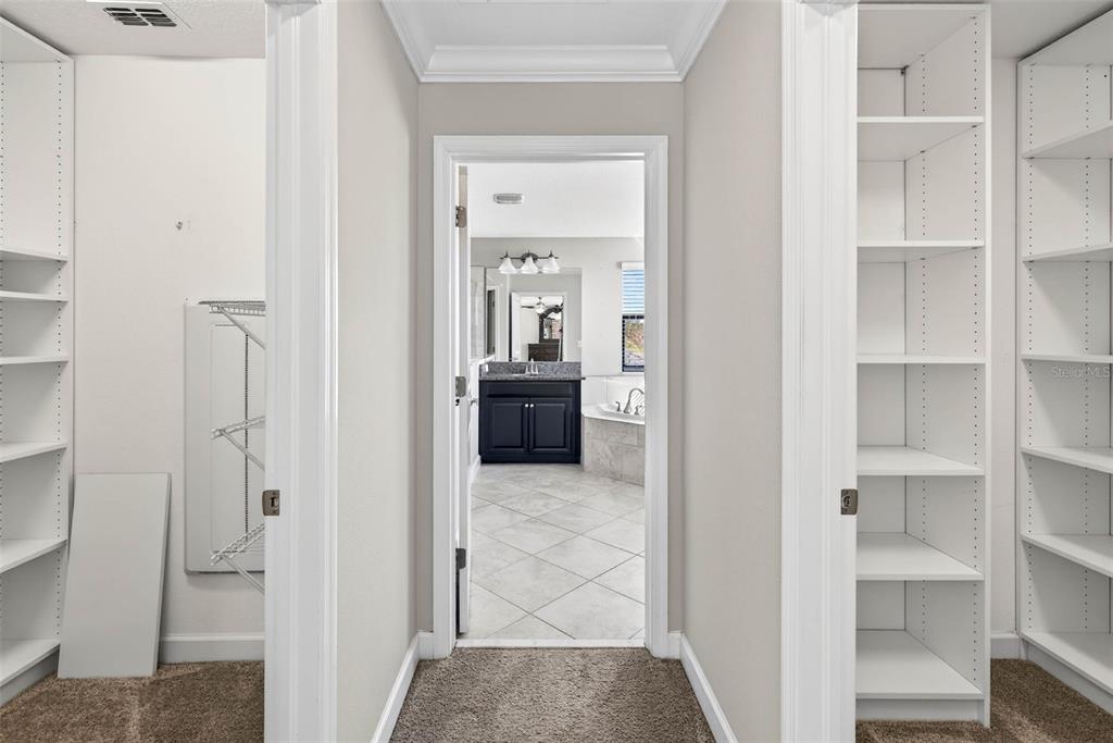 9906 Victory Gallop Loop Ruskin, FL 33573 - Photo 8 of 18 a view of a hallway with wooden floor and entryway