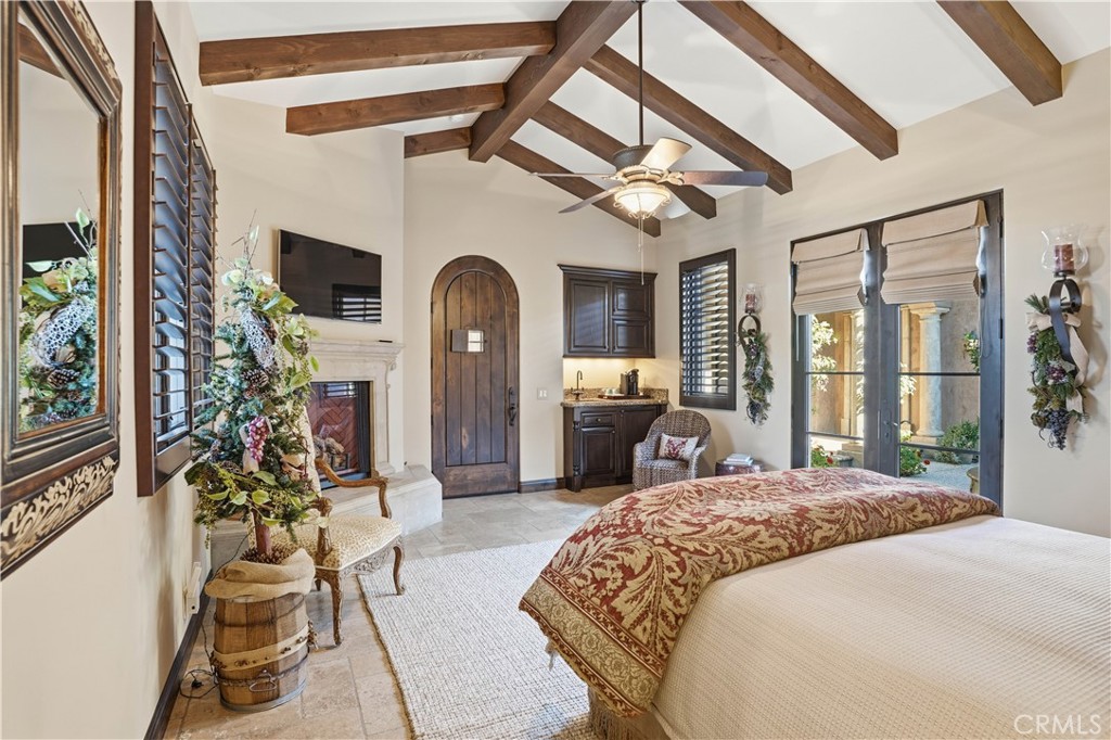 34965 Via Del Ponte Temecula Ca Temecula, CA 92592 - Photo 14 of 75 a bedroom with a bed flat screen tv and a large window with the outer view