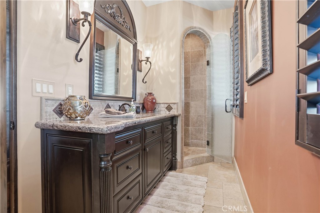 34965 Via Del Ponte Temecula Ca Temecula, CA 92592 - Photo 15 of 75 a bathroom with a granite countertop sink a mirror and a shower