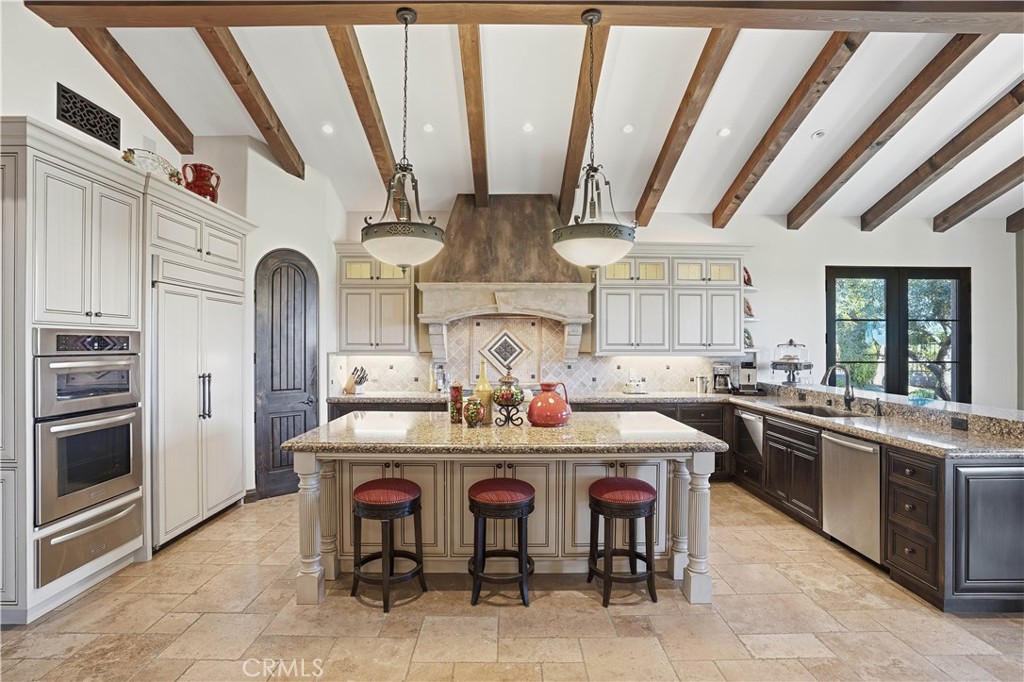 34965 Via Del Ponte Temecula Ca Temecula, CA 92592 - Photo 27 of 75 a kitchen with stainless steel appliances granite countertop a stove a sink dishwasher and cabinets