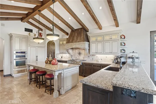 a view of a chair and table in backyard of the house