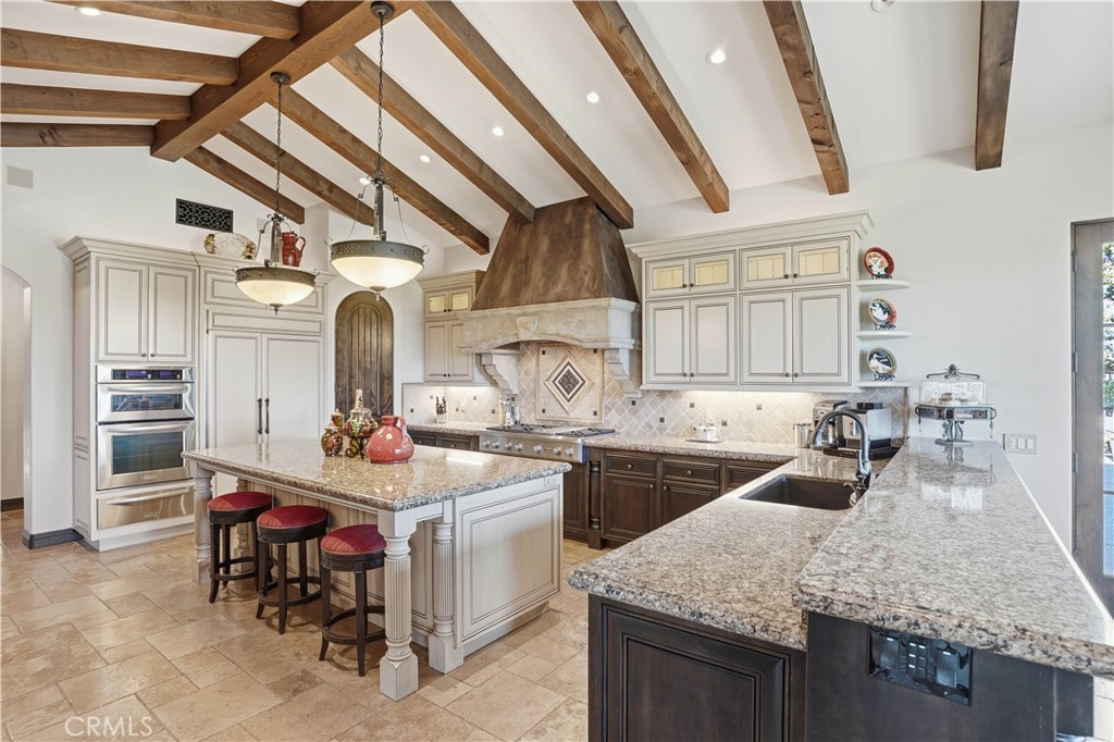 34965 Via Del Ponte Temecula Ca Temecula, CA 92592 - Photo 28 of 75 a kitchen with a sink a stove and chairs