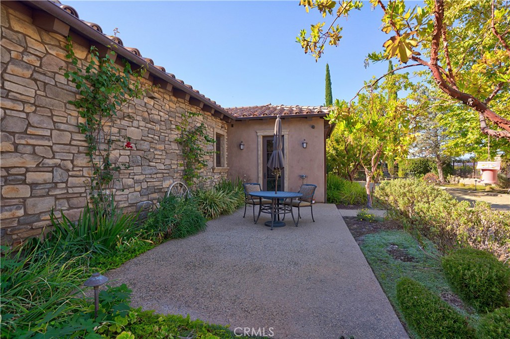 34965 Via Del Ponte Temecula Ca Temecula, CA 92592 - Photo 39 of 75 a view of a chair and table in backyard of the house
