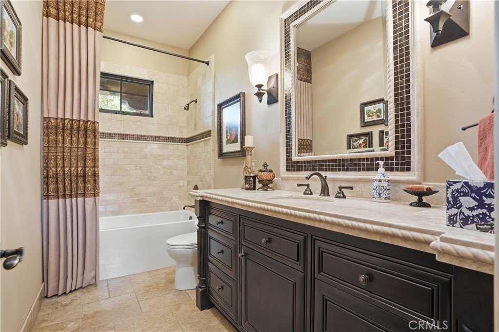 34965 Via Del Ponte Temecula Ca Temecula, CA 92592 - Photo 44 of 75 a bathroom with a sink double vanity granite tub shower and a mirror