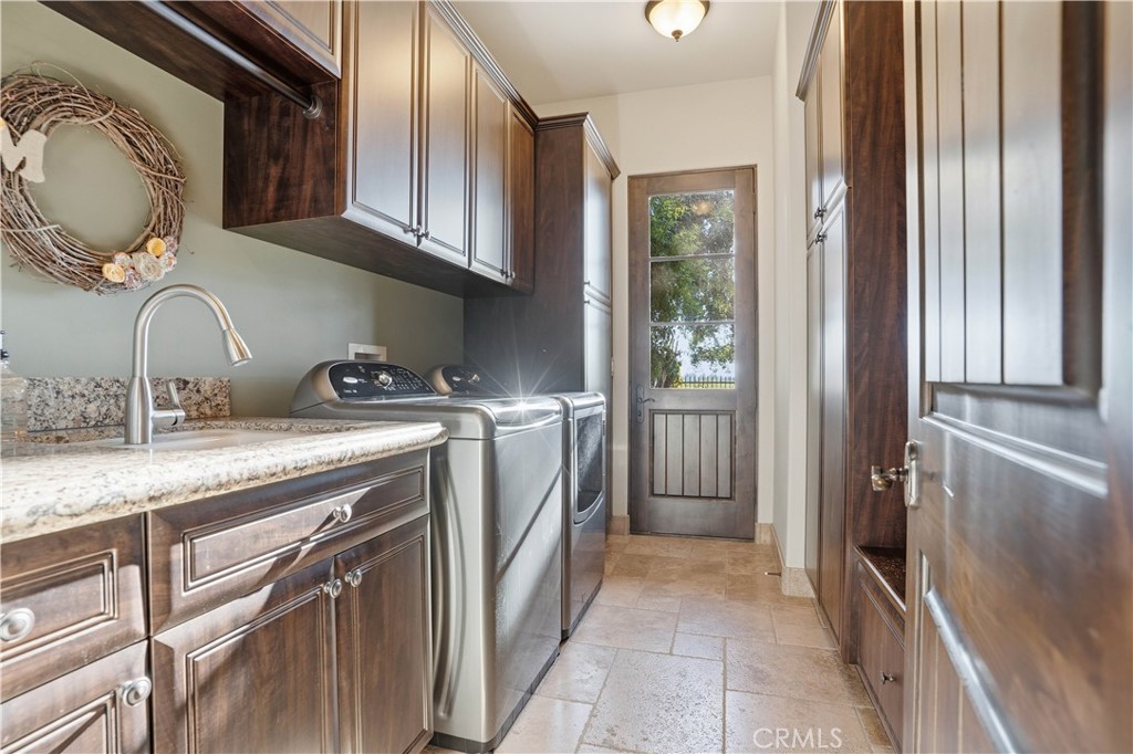 34965 Via Del Ponte Temecula Ca Temecula, CA 92592 - Photo 45 of 75 a utility room with a sink a washer and dryer