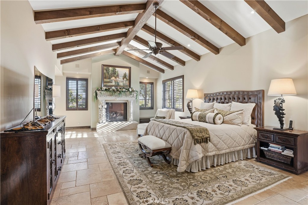 34965 Via Del Ponte Temecula Ca Temecula, CA 92592 - Photo 46 of 75 a spacious bedroom with a bed a chandelier and couches
