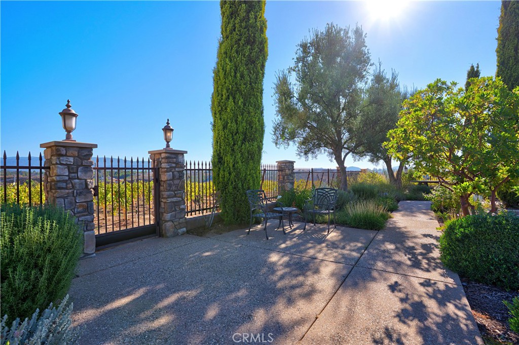 34965 Via Del Ponte Temecula Ca Temecula, CA 92592 - Photo 63 of 75 a view of a pathway with a wrought fence