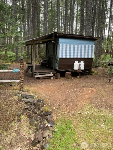 a backyard of a house with barbeque oven table and chairs