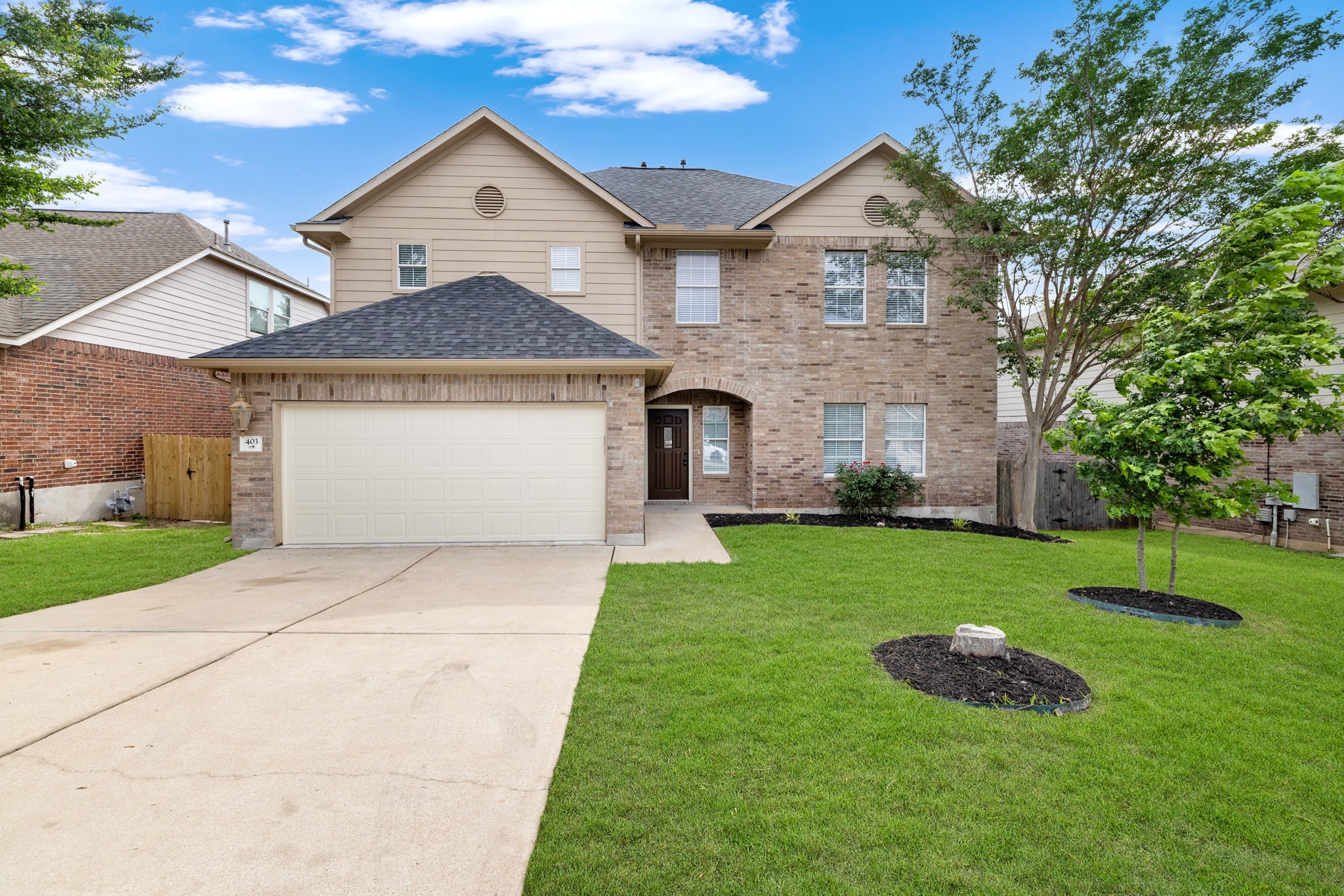 403 Red Hawk Drive Leander, TX 78641 - Photo 1 of 37 Two-story home featuring a brick and siding exterior, an attached two-car garage, and a concrete driveway