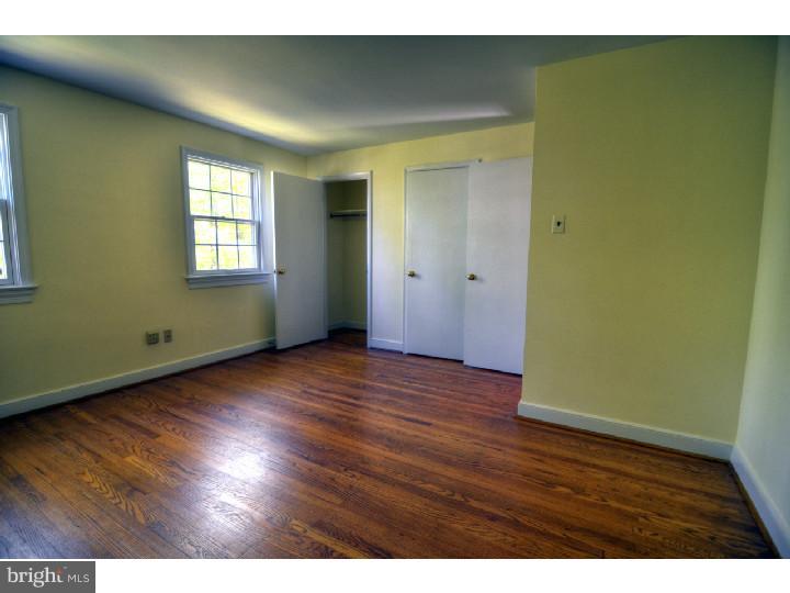 743 West Valley Road Wayne, PA 19087 - Photo 22 of 25 a view of an empty room with wooden floor and a window