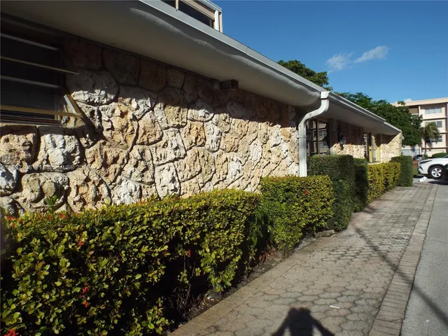 a view of a patio with table and chairs and potted plants