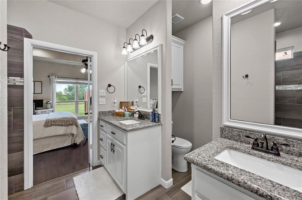 6093 Farm To Market Road 730 North Decatur, TX 76234 - Photo 12 of 28 a en suite bathroom with a granite countertop double vanity sink a mirror and a shower