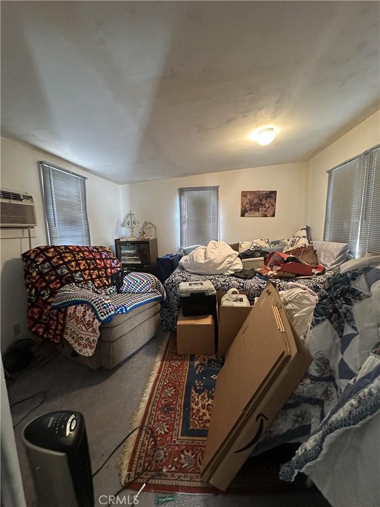 55710 Chaparral Road Yucca Valley, CA 92284 - Photo 11 of 18 a bed room with a bed window and a couch