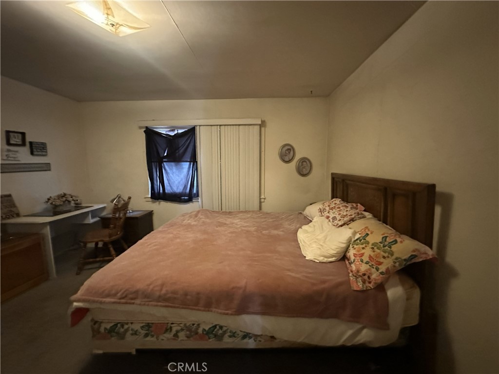 55710 Chaparral Road Yucca Valley, CA 92284 - Photo 12 of 18 a bedroom with a bed and a dresser