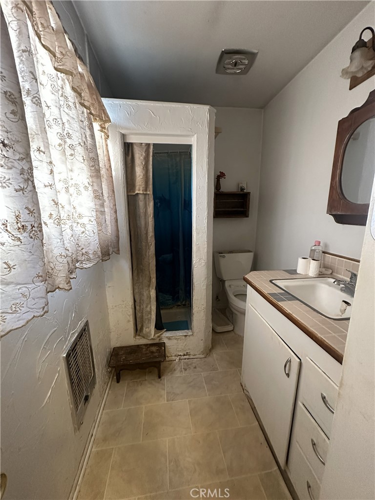 55710 Chaparral Road Yucca Valley, CA 92284 - Photo 14 of 18 a bathroom with a sink and a mirror