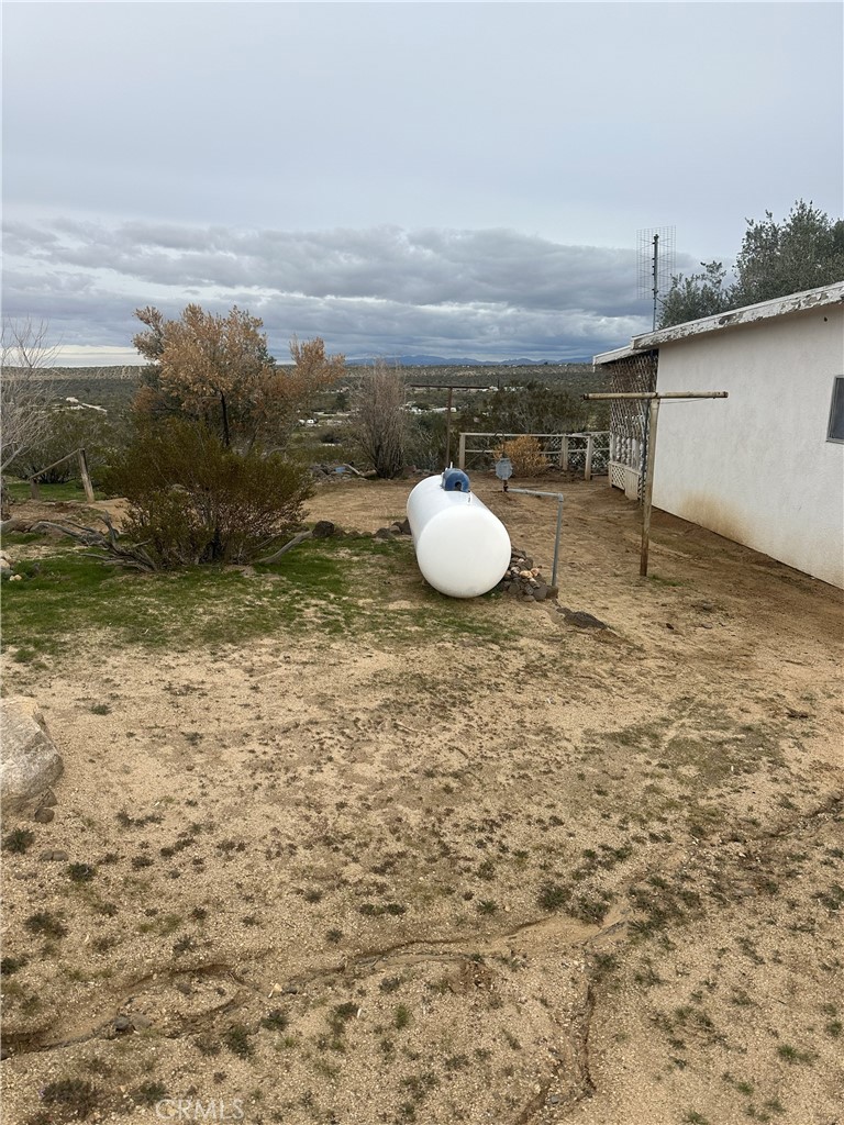 55710 Chaparral Road Yucca Valley, CA 92284 - Photo 6 of 18 a view of a dry yard with wooden fence