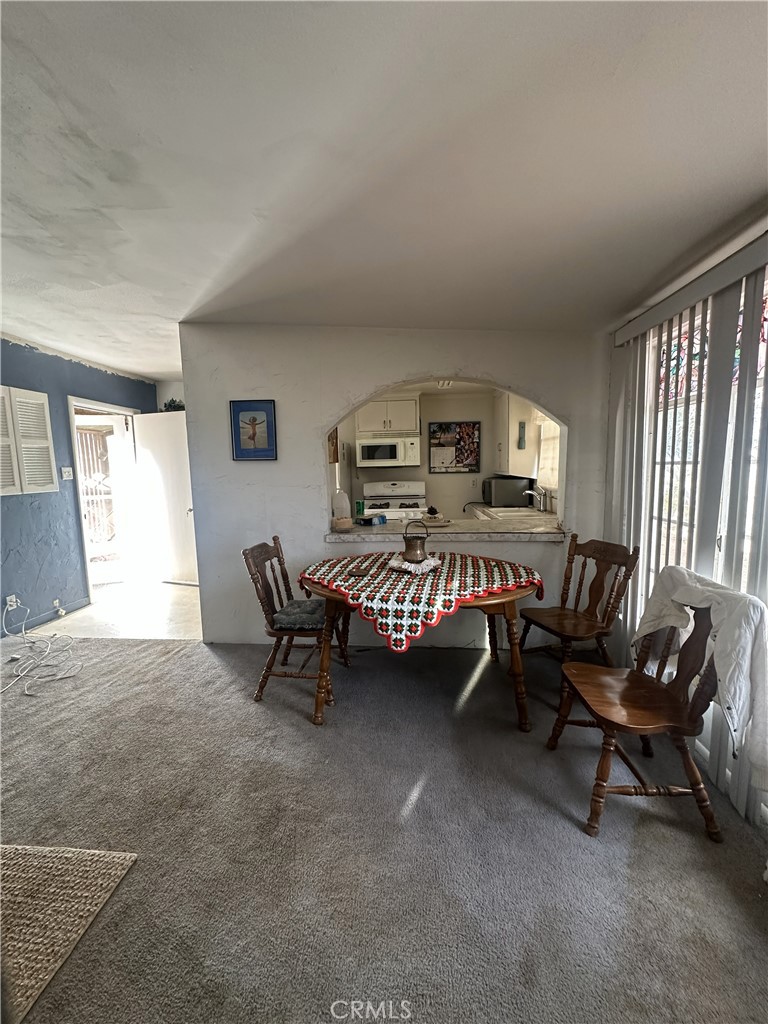 55710 Chaparral Road Yucca Valley, CA 92284 - Photo 8 of 18 a living room with furniture and a flat screen tv