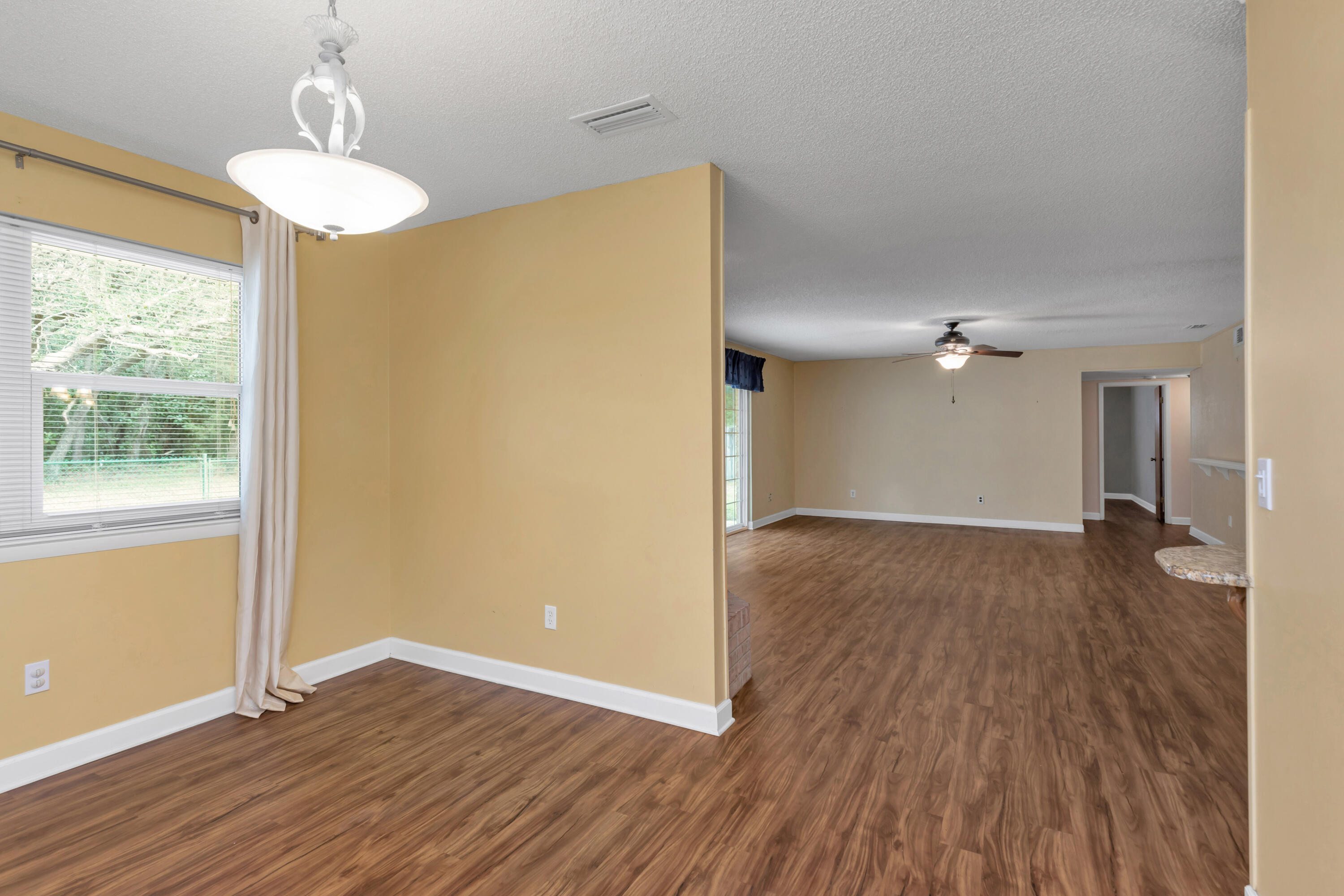 129 12th Avenue Shalimar, FL 32579 - Photo 14 of 36 a view of empty room with wooden floor and fan