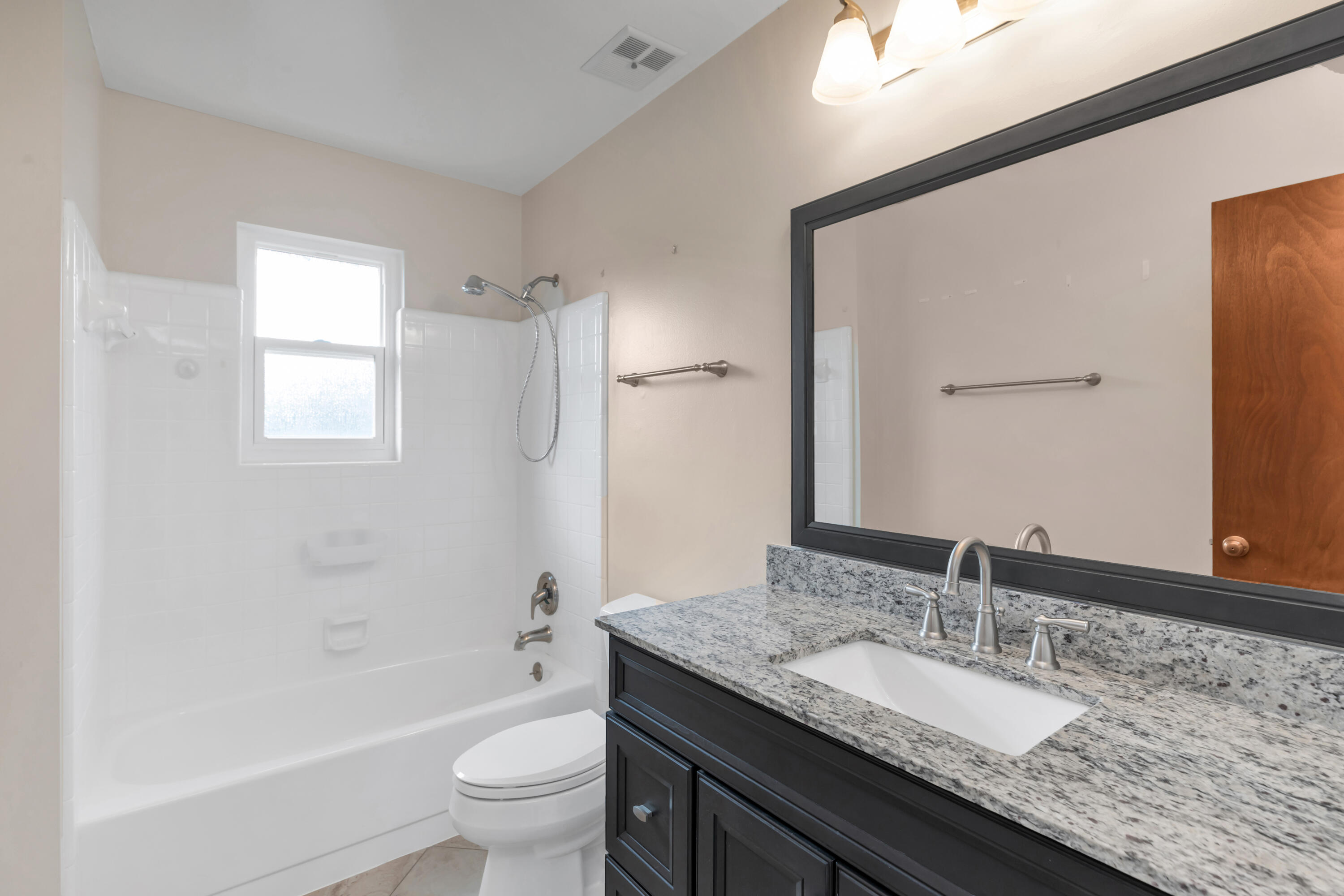 129 12th Avenue Shalimar, FL 32579 - Photo 19 of 36 a bathroom with a granite countertop sink toilet and shower