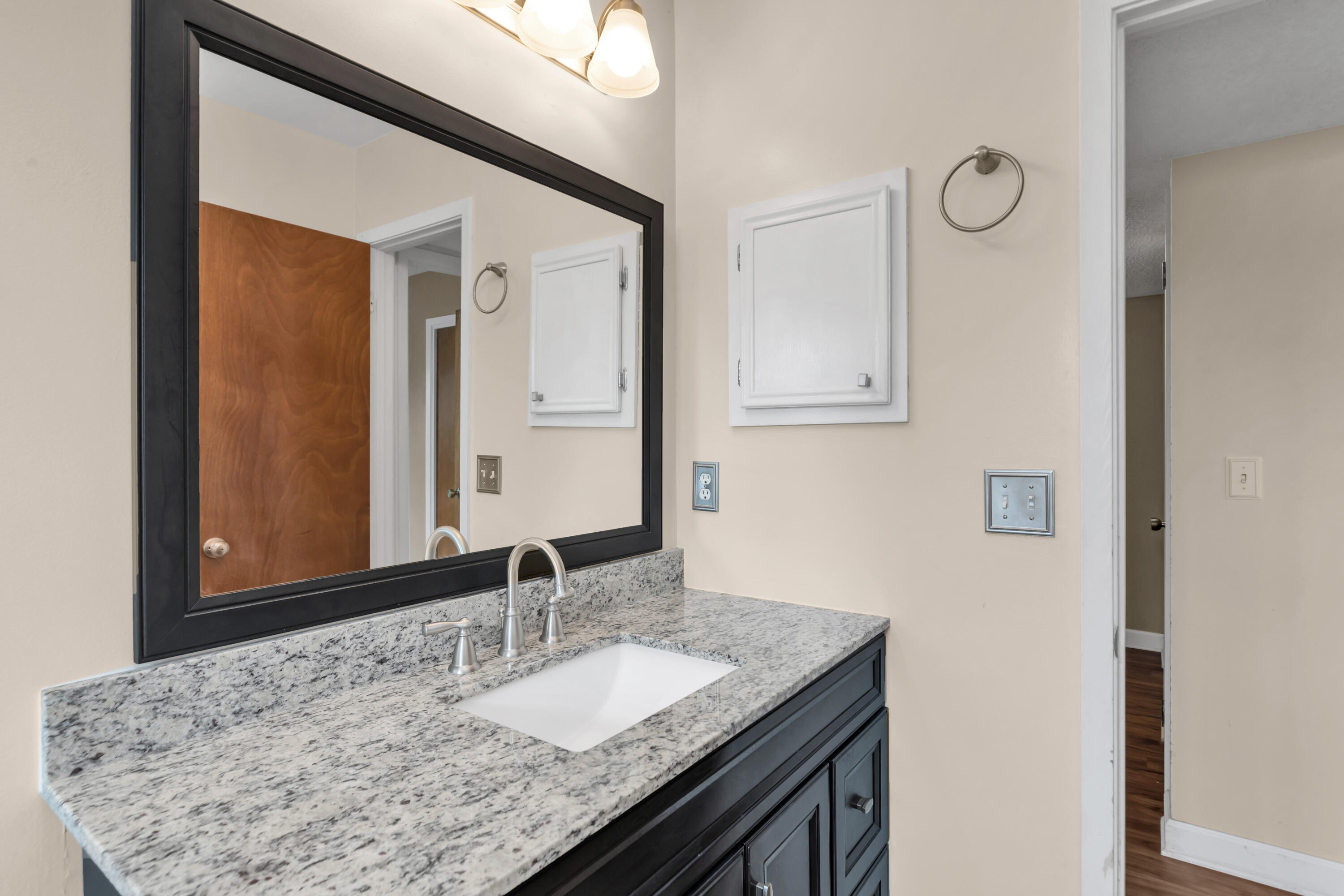 129 12th Avenue Shalimar, FL 32579 - Photo 20 of 36 a bathroom with a granite countertop sink and a mirror